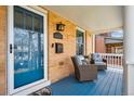 Cozy front porch with blue floor, chairs, and stylish brick exterior at 1074 S Corona St, Denver, CO 80209