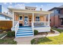 Inviting front porch with blue painted steps and classic white columns at 1074 S Corona St, Denver, CO 80209