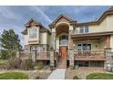 Charming two-story home with stone accents, a welcoming porch, and beautiful landscaping at 13 Tamarade Dr, Littleton, CO 80127