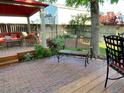 Backyard patio featuring ample seating, a wooden deck, and a well-manicured garden at 742 Mockingbird Ln, Brighton, CO 80601
