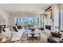 Spacious living room with a modern fireplace, comfortable seating, and sliding glass doors to a relaxing outdoor balcony at 1768 Peak Loop, Broomfield, CO 80023