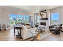 Light-filled living room boasts a contemporary fireplace, chic furnishings, and an inviting view from a large balcony at 1768 Peak Loop, Broomfield, CO 80023