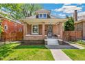 Charming brick home with inviting porch, manicured lawn, and classic architectural details at 2738 W 38Th Ave, Denver, CO 80211