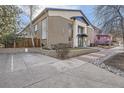 Brick building featuring parking and landscaping, showcasing the front facade at 2460 W Caithness Pl # 104, Denver, CO 80211
