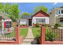 Charming home featuring a well-maintained front yard with a walkway leading to the front door and a 'For Sale' sign at 3024 S Sherman St, Englewood, CO 80113