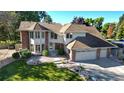 A well-maintained two-story home with brick accents, a large garage, and a landscaped yard at 4998 W 101St Ave, Westminster, CO 80031