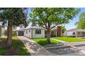 A home with a detached garage, mature trees, and a well-maintained lawn at 5369 S Sherman St, Littleton, CO 80121