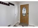 Inviting entryway with an oak front door with decorative glass and coat rack at 6280 Quay St, Arvada, CO 80003