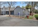 Gray home with drought-resistant landscaping, view of adjoining home and neighborhood street at 1972 S Carr St, Lakewood, CO 80227