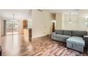 Open-concept living room with wood floors, vaulted ceiling, and neutral paint at 18981 E Mercer Dr, Aurora, CO 80013