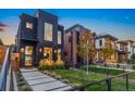 Contemporary black home with unique architectural features, landscaped front yard and modern fence at 3709 Tejon St, Denver, CO 80211