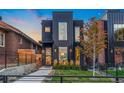 Striking black home with a modern design, large windows, and well-maintained front yard at 3709 Tejon St, Denver, CO 80211