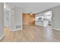 An open floor plan features a bright kitchen and dining area with wood accent wall at 9501 W 89Th Cir, Broomfield, CO 80021