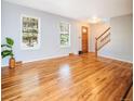 Bright living room with hardwood floors, fresh paint, and lots of natural light from the large windows at 2523 E Geddes Ave, Centennial, CO 80122