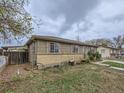 Exterior view of the home with a modest front yard and partial fencing at 5481 Xanadu St, Denver, CO 80239