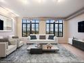 Bright living room featuring large windows and comfortable seating arrangement at 7110 W Alaska Dr # A, Lakewood, CO 80226