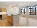 Bright open space with hardwood floors, granite island, and stainless appliances offers great room to entertain at 7110 W Alaska Dr # A, Lakewood, CO 80226
