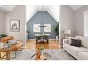 Elegant dining room with vaulted ceiling, hardwood floors, and modern chandelier at 1290 S Elizabeth St, Denver, CO 80210