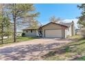 Charming home with an attached two-car garage and a quaint front entrance with comfortable outdoor seating at 2166 Appaloosa Trl, Elizabeth, CO 80107