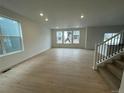 Bright living room featuring hardwood floors, recessed lighting, and large windows at 28625 E 6Th Pl, Watkins, CO 80137