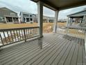 View of the porch with wood style flooring and white railings in new construction at 28625 E 6Th Pl, Watkins, CO 80137