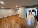 Spacious living room showcasing hardwood floors, neutral paint, and access to other rooms at 528 S Youngfield Ct, Denver, CO 80228