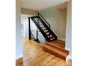 Modern staircase features hardwood steps, sleek black railings, and bright lighting at 528 S Youngfield Ct, Denver, CO 80228