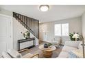 Living area with modern staircase and comfortable seating at 4336 Decatur St, Denver, CO 80211