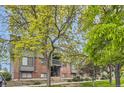 Exterior view of building showcasing mature trees and landscaping at 3558 S Depew St # 302, Denver, CO 80235