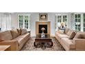 Sun-filled living room with a stone fireplace, large windows, and hardwood floors at 1502 Columbine Ave, Boulder, CO 80302