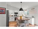 Bright kitchen with white cabinets, stainless steel appliances, and wood flooring at 5494 S Ireland St, Centennial, CO 80015