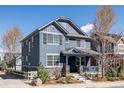 Charming two-story home with stone accents, a covered front porch, and manicured landscaping at 2879 Shadow Lake Rd, Lafayette, CO 80026
