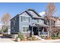 Beautiful two-story home with blue siding, stone accents, covered porch, and well-maintained landscaping at 2879 Shadow Lake Rd, Lafayette, CO 80026