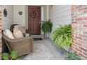 Inviting front porch with cozy seating and decorative wreath, offering a warm welcome at 16753 W 61St Ln, Golden, CO 80403