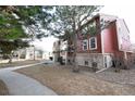 Side view of red building, landscaping, and a paved walkway at 2686 E Otero Pl # 12, Centennial, CO 80122