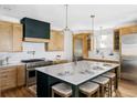 Gourmet kitchen with stainless steel appliances, custom cabinetry, and a large center island at 1683 N Zenobia St, Denver, CO 80204