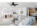 Bright living space features a large sectional, hardwood floors, and modern light fixtures at 1683 N Zenobia St, Denver, CO 80204