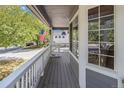 Inviting covered front porch with white railing, overlooking a tree-lined street at 821 S 34Th Ave, Brighton, CO 80601