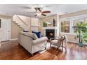 Inviting living room with fireplace, hardwood floors, ceiling fan and natural light at 2891 S Vaughn Way, Aurora, CO 80014
