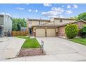 Charming two-story home with a two car garage, brick accents, and a well maintained front yard at 12702 Fairfax St, Thornton, CO 80241