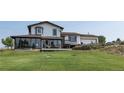 Charming two-story home featuring a sunroom, inviting deck, and well-maintained lawn at 1143 Belgian Trl, Elizabeth, CO 80107