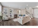 Cozy living room with a fireplace, built-in shelves, and modern decor with an open staircase at 540 E Fremont Pl, Centennial, CO 80122
