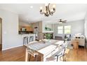 Open floorplan with dining room table and view into the living room fireplace at 14247 W 84Th Cir # A, Arvada, CO 80005