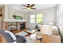 Comfortable living room with a cozy fireplace, large windows, and neutral decor for a relaxing atmosphere at 14247 W 84Th Cir # A, Arvada, CO 80005