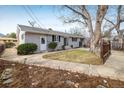 Backyard featuring concrete walkway, mature trees, small garden and established lawn at 350 Auburn St, Boulder, CO 80305