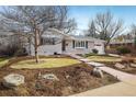 Charming single-story home featuring a brick facade, well-maintained landscaping, and an attached garage at 350 Auburn St, Boulder, CO 80305