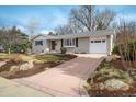 Charming single-story home featuring a brick facade, well-maintained landscaping, and an attached garage at 350 Auburn St, Boulder, CO 80305