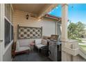 Cozy porch featuring comfortable seating, a barbecue grill, and decorative string lights for outdoor relaxation and entertaining at 3096 W Prentice Ave # G, Littleton, CO 80123