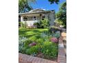 Beautifully landscaped front yard with lush greenery and colorful flowers at 4057 Bryant St, Denver, CO 80211