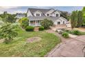 Charming two-story home with a covered porch and lush landscaping at 10170 E 151St Ct, Brighton, CO 80602